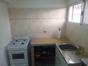 a kitchen with a stove and a sink at El mejor descanso lll in Plottier +6 photos