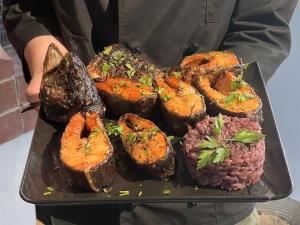 a person holding a tray of food on a plate at Sevan Resort No5 in Chʼkalovka
