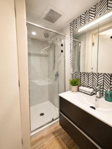 a bathroom with a shower and a sink at Evergreen House in Vancouver