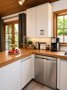 a kitchen with white cabinets and a plate of fruit at Evergreen House in Vancouver
