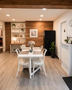 a dining room with a white table and white chairs at Evergreen House in Vancouver +21 photos