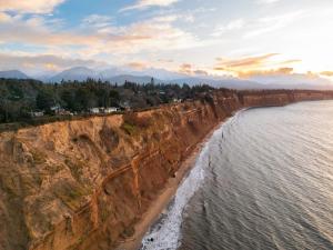 an aerial view of the cliffs next to the ocean at Private Blufftop Oceanview Hot Tub Fire Pit in Port Angeles