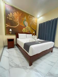 a bedroom with a bed with a painting on the wall at Coastal Haven Resort in Siquijor +34 photos