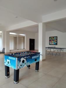 a table in a room with a soccer table at Oshana Stays,Fully furnished Studio Apartment with Pool,Sauna,Siolim, Goa in Mapusa
