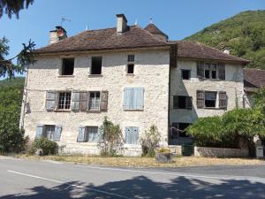 an old stone house on the side of the road at Room - Les loups bleus in Rossillon