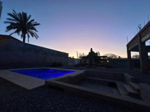 a swimming pool with blue lights in a yard at Casa Caribe in San Felipe