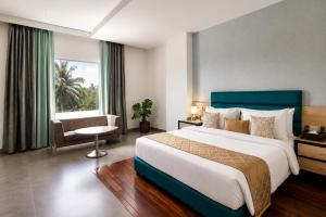 a hotel room with a large bed and a window at Hotel Star City in Chennai