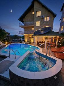 a large swimming pool in front of a building at Apartments Nikolić in Soko Banja