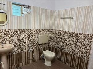 a bathroom with a toilet and a sink at Kuppath Inn in Cochin +33 photos