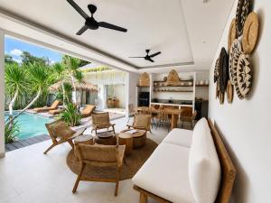 a living room with a white couch and a table at Villa Mei 2BR Pool, 200m from Seseh Beach in Dalung