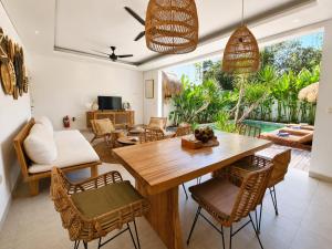 a living room with a wooden table and chairs at Villa Mei 2BR Pool, 200m from Seseh Beach in Dalung