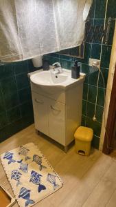 a bathroom with a sink and a rug on the floor at Cutigliano con vista in Cutigliano +2 photos