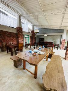 a large room with a large wooden table and chairs at City Hub Transit in Katunayaka