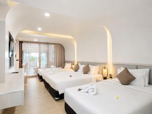 a hotel room with three beds and a tv at Chaolao Cabana Resort in Chao Lao Beach +113 photos