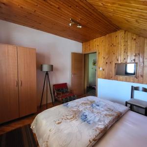 a bedroom with a large bed in a room with wooden ceilings at Kozorog Durmitor in Žabljak +54 photos