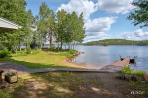 a view of a lake with a dock at Villa Repovesi in Hillosensalmi