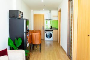 a living room with a refrigerator and a kitchen at The BHA Riverside in Danang