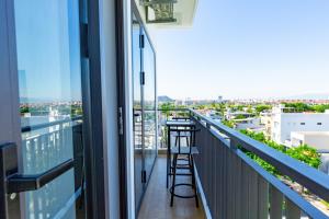 a balcony with stools and a view of the city at The BHA Riverside in Danang