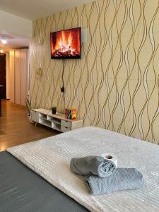 a bedroom with a bed with a tv on the wall at Abreeza place tower 1 in Davao City