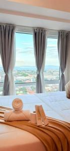 a bedroom with a bed with a large window at Abreeza place tower 1 in Davao City
