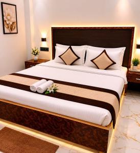 a bedroom with a large bed with white pillows at HOTEL SAMAY Rajgir in Rājgīr