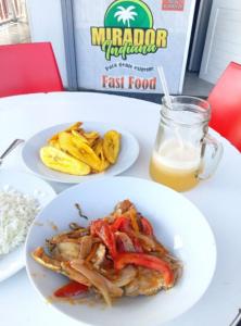 a table with two plates of food and a glass of orange juice at Indiana Lodge in Santa Clara +23 photos