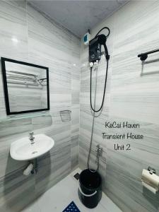 a bathroom with a sink and a shower at Kecai Haven Transient House in Digos