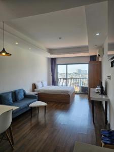 a bedroom with a bed and a couch in a room at SAIGON GARDEN HILL Resort & Apartment in Ho Chi Minh City +96 photos