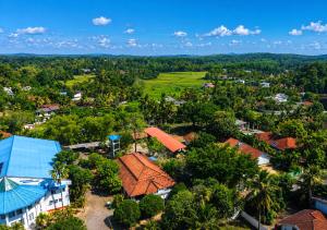an aerial view of a small town in the middle of a forest at Secret Paradise Edge in Weligama
