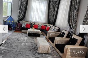 a living room with a couch and a table at Moy dom Ganja in Bagbanlar