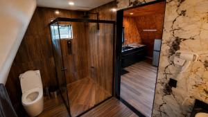 a bathroom with a shower and a toilet and a sink at Chalé Queen in Brasília