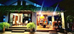 a house with a patio with a table and chairs at Ratchawong Place ราชวงศ์ เพลส --หลังพ่อขุน-- in Phayao