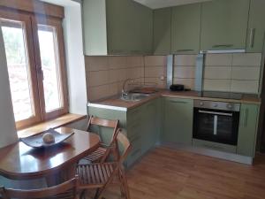 a kitchen with a table and chairs and a sink at Eternal blue in Volos +54 photos