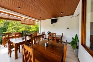 a dining room with a table and chairs at Lion See Hotel - Sigiriya in Sigiriya