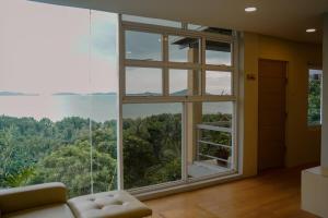 a living room with a large window with a view at Mamima BnB in Caramoan