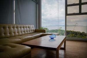 a living room with a couch and a coffee table at Mamima BnB in Caramoan