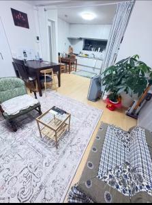 a living room with a couch and a table at guest house REST in Kubogayato