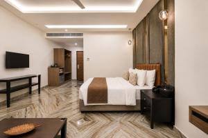 a hotel room with a bed and a desk at Hotel Star City in Chennai