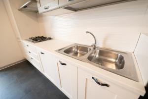 a kitchen with a sink and a stove at Dimora Altea in Taranto +20 photos