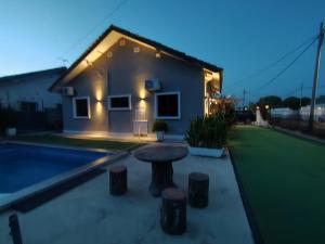 a house with a table in front of it at MELAKA BEACH VILLA ( A TYPE ) in Kelebang Besar