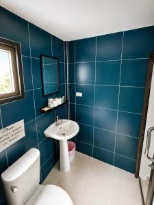 a blue bathroom with a toilet and a sink at Villa Giacomelli Samui in Taling Ngam Beach +37 photos
