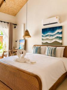 a bedroom with a large bed with a swan on it at Nitiporn Resort kohphayam & seaagain bar and restaurants in Ko Phayam +39 photos
