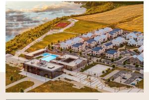 an aerial view of a large house with a pool at Lake side story in Frumuşani