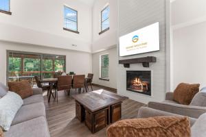 a living room with a fireplace and a table at Lumberjack Lodge with Amenities in Hollister