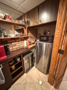 a kitchen with a stainless steel refrigerator with a microwave at TnTBnB in Combined Locks