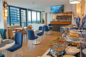 a restaurant with a buffet of food on a table at The Infinity Panorama Batumi in Batumi