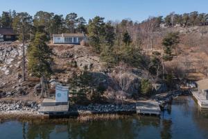 an aerial view of a house next to a lake at Spectacular lake plot, Stockholm archipelago in Dalarö