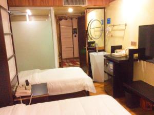 Voodi või voodid majutusasutuse Guangzhou Bird Island Hotel toas