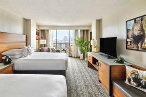 a hotel room with two beds and a flat screen tv at San Antonio Marriott Riverwalk in San Antonio