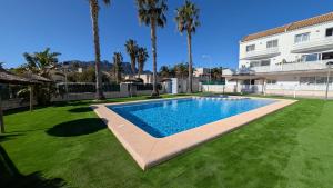 a swimming pool in a yard next to a building at Casa Isabel in El Verger